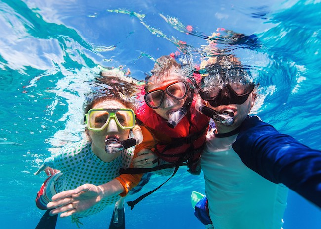 Amber showing a starfish in the crystal clear waters of Cozumel island.