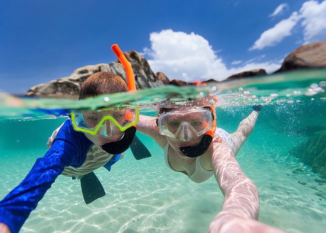 Desiree and her brother snorkeling in the beach.