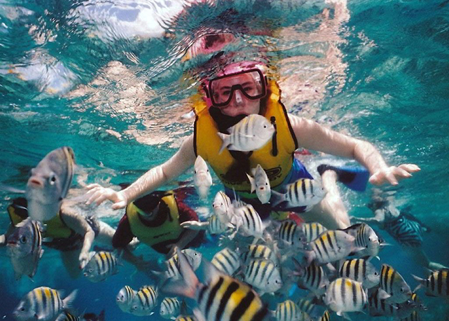 Emily excited snorkeling behind the fish with her family and friends.